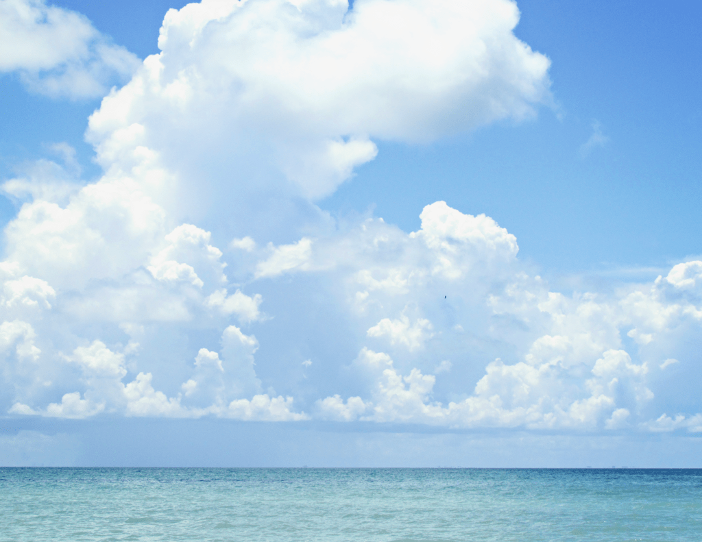 puffy-white-clouds-on-beach