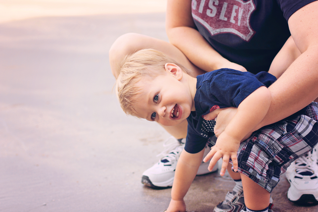 toddler-boy-galveston-beach-touching-sand-first-time