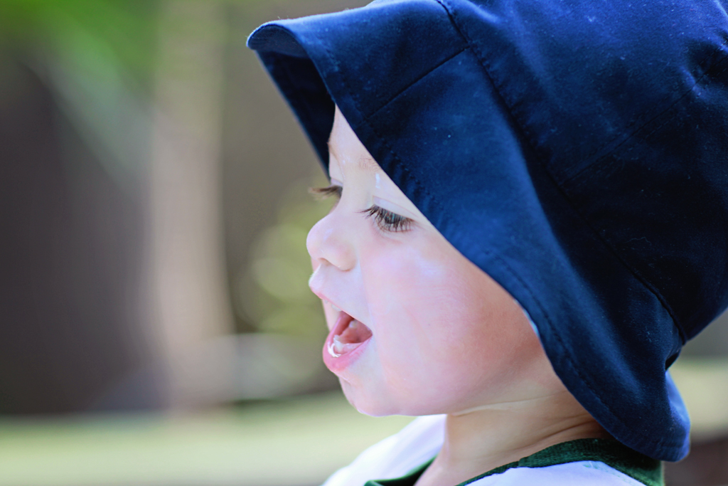 toddler-playing-outside-with-hat-and-sunscreen