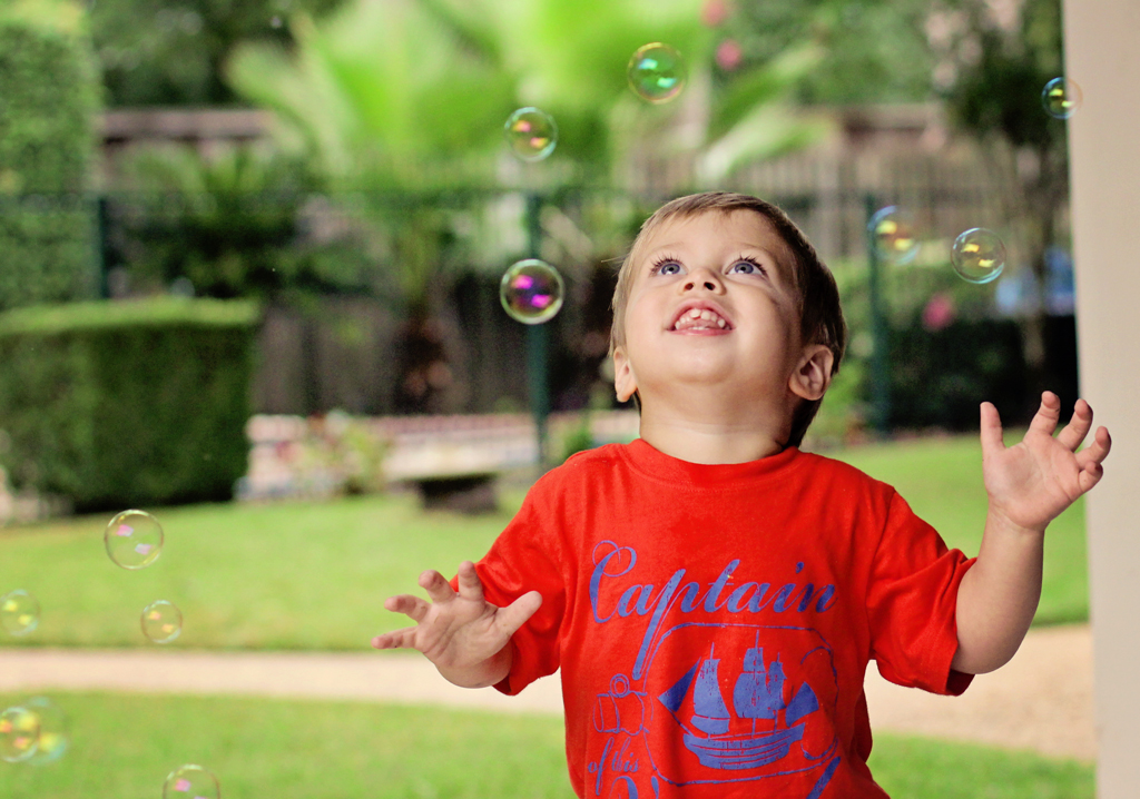 two-year-old-playing-in-bubbles